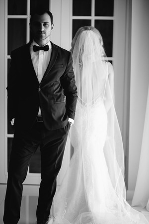 Bride and groom at the wedding Day. Wedding couple, happy newlywed woman and man, in a beautiful hotel room, studio. Loving couple. Bride and groomの写真素材