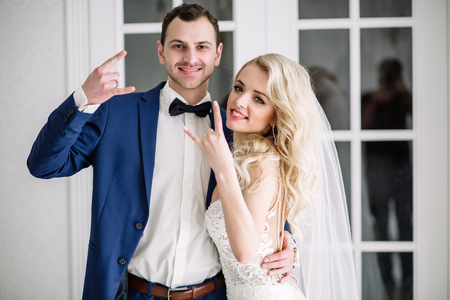 Bride and groom at the wedding Day. Wedding couple, happy newlywed woman and man, in a beautiful hotel room, studio. Loving couple. Bride and groomの写真素材