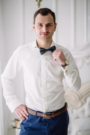 male portrait in butterfly and white shirtの写真素材