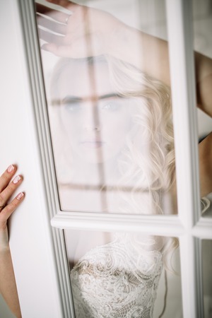 Fashionable and modern bride, beautiful blonde girl, smiling with happiness and loveの写真素材