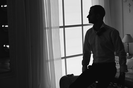 male portrait in butterfly and white shirtの写真素材