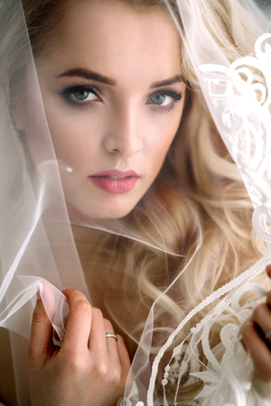 Fashionable and modern bride, beautiful blonde girl, smiling with happiness and loveの写真素材