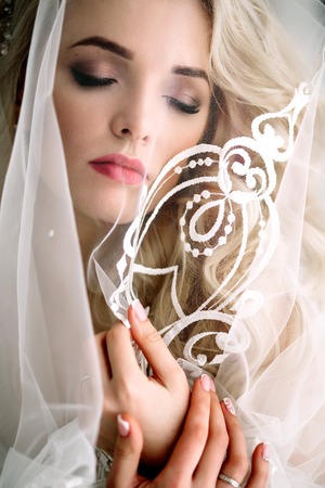 Fashionable and modern bride, beautiful blonde girl, smiling with happiness and loveの写真素材