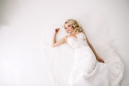 Fashionable and modern bride, beautiful blonde girl, smiling with happiness and loveの写真素材