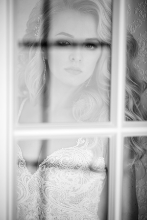 Fashionable and modern bride, beautiful blonde girl, smiling with happiness and loveの写真素材