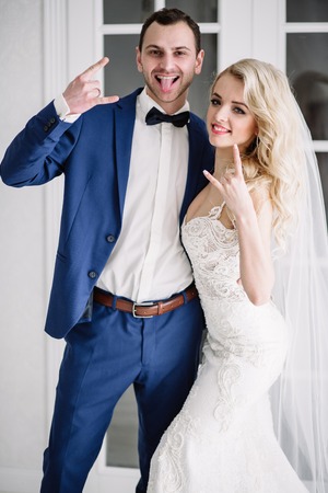 Bride and groom at the wedding Day. Wedding couple, happy newlywed woman and man, in a beautiful hotel room, studio. Loving couple. Bride and groomの写真素材