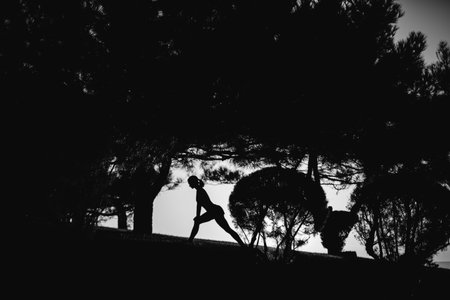 beautiful girl with sports forms sports on the beach, drinking water, jumping, running, doing different exercisesの写真素材
