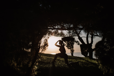 beautiful girl with sports forms sports on the beach, drinking water, jumping, running, doing different exercisesの写真素材
