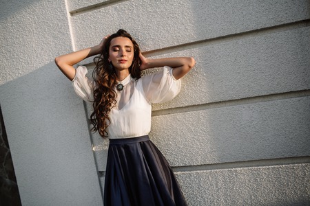 Portrait of beautiful young brunette woman in a long blue dressの写真素材