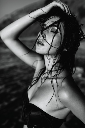 sexy girl of Asian appearance in her swimsuit on the sea with sand, fashionの写真素材