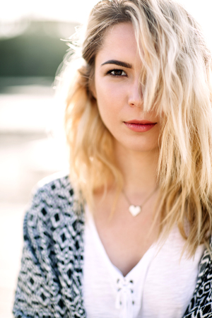 Blonde girl on the beach of the sandy beach by the sea.の写真素材