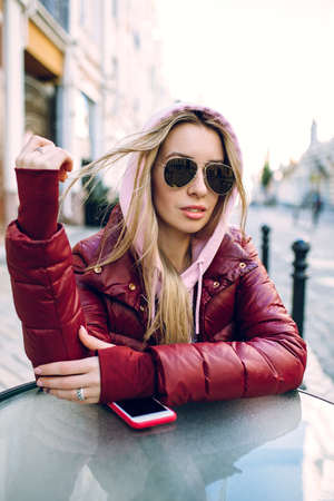 Stylish hipster girl in the retro jeans suit posingの写真素材