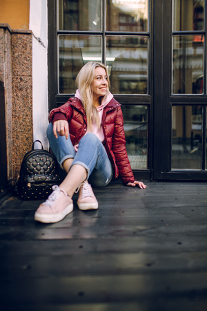 Stylish hipster girl in the retro jeans suit posingの写真素材