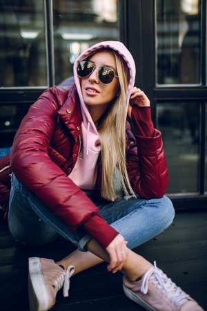 Stylish hipster girl in the retro jeans suit posingの写真素材