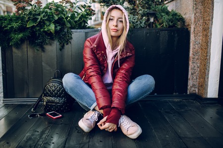 Stylish hipster girl in the retro jeans suit posingの写真素材