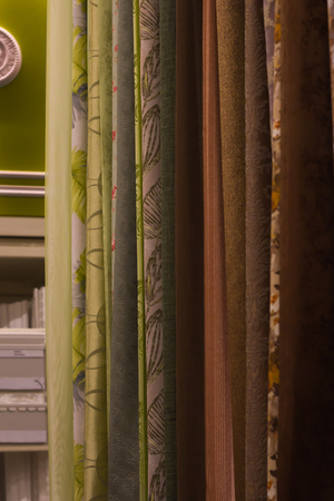 Assortment of beautiful curtain hanging samples in shop upright close up, shooting angleの写真素材