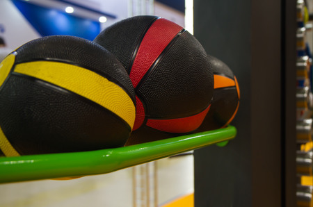 several colored basketballs lying on the shelf in the gym for workouts close upの写真素材
