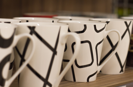 Tea cups on store shelves stand in a rowの写真素材