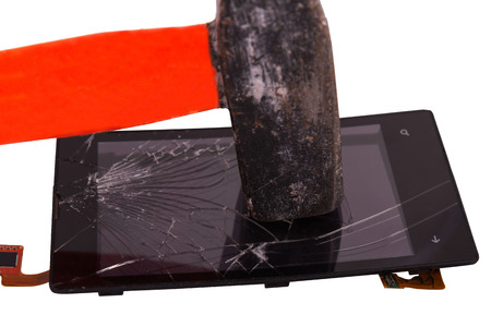 hammer blow on the display of the mobile phone, cracked on the touchscreen. hammer a high-tech deviceの写真素材