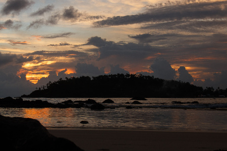 Scenic twilight view at water and cloudy sky, Mirissa beach, Sri Lankaの写真素材