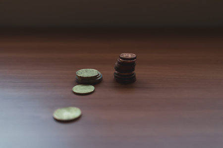 Stack coins on desk. Paperboard background. Money concept.