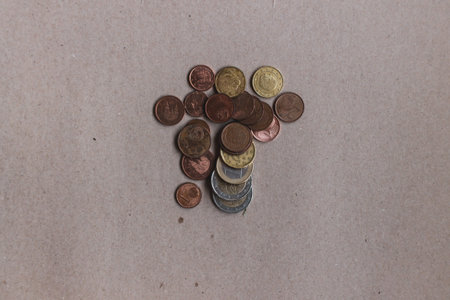 Stack coins on desk. Paperboard background. Money concept.