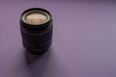 Camera lens on a purple background.