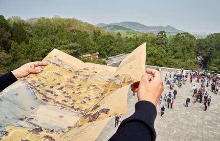 Beijing, China, April 12, 2017: Traveler searching direction on location mapのeditorial素材