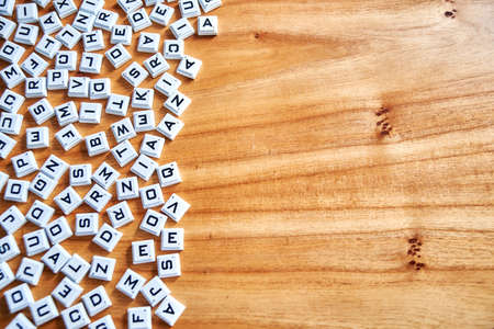 Buenos Aires, Argentina, September 28, 2020: Random letters on a wooden backgroundのeditorial素材