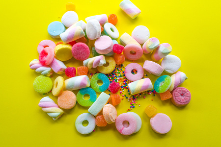 gummies and candies on yellow backgroundの写真素材