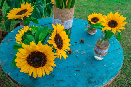 decoration with sunflowers on blue table outdoors on country estateの写真素材