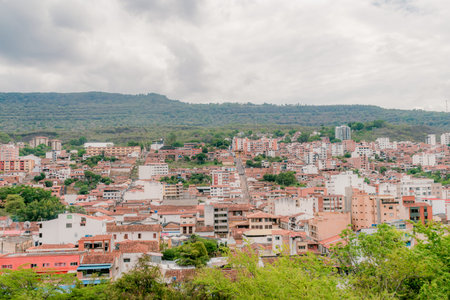 landscape of the city of San Gil, Santander, Colombia from the mountains, with green vegetation in the foreground that highlights the green surroundings of the cityの写真素材