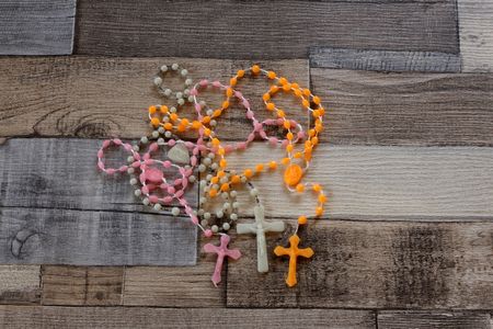 Color rosary beads on wooden backgroundの写真素材