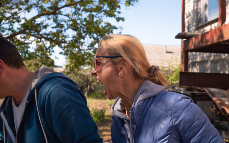 Expressive blonde woman yells at husbandの写真素材