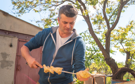Adult man prepare meat for cookingの写真素材