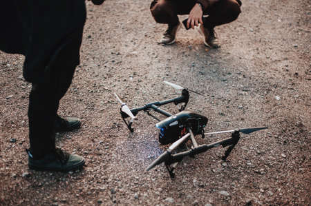 Two pilots preparing drone for flightの写真素材