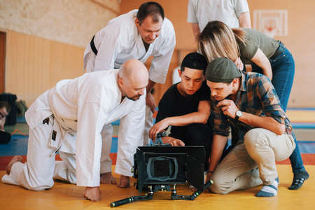 Filming crew watches video materials on the stageの写真素材