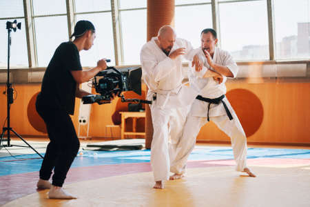 Operator with camera runs around fighters on sparingの写真素材