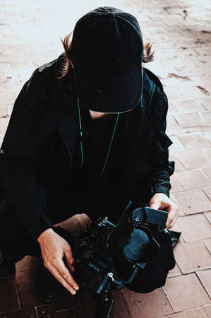 Haired guy from shooting team corrects focus on cameraの写真素材
