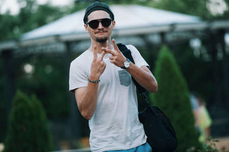 Bearded young man smiling and show V sign to cameraの写真素材