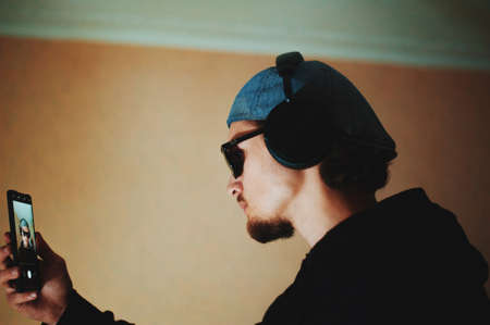 Anchor bearded guy in hat and headphones makes selfieの写真素材
