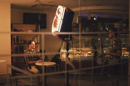 Backstage shooting in cozy cafeの写真素材