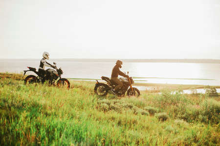 Man and woman on bikes near the seaの写真素材