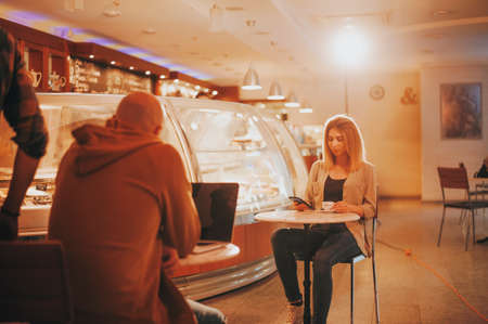 Cute blonde and bold man sits opposite each other.の写真素材
