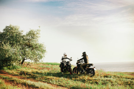 Two mans on bikes on the field