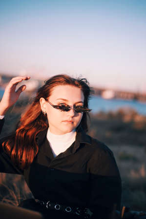 Beauty Modern styled girl in fire shaped sunglassesの写真素材