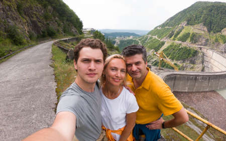 Wide-angle selfie of happy family traveling Georgian mountainsの写真素材