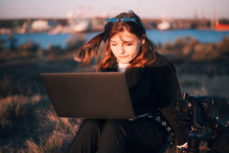 Emotional face of girl works on laptopの写真素材