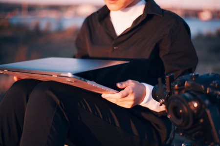 close-up of girl who takes a laptop on knees near the camera