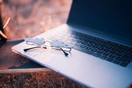 Fire shaped sunglasses on laptopの写真素材